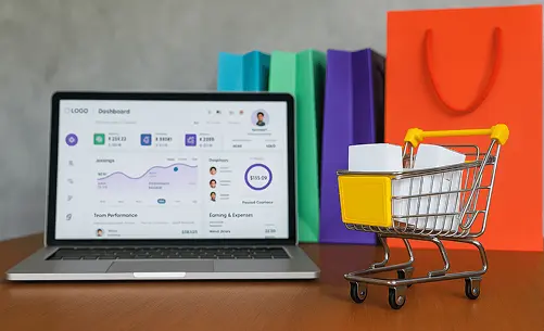 Laptop showing a dashboard with shopping bags and a cart